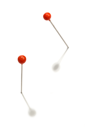pins with red head on a white background の写真素材