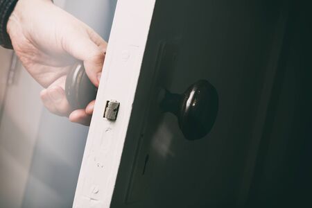 old wooden door with door knob, close up.の写真素材