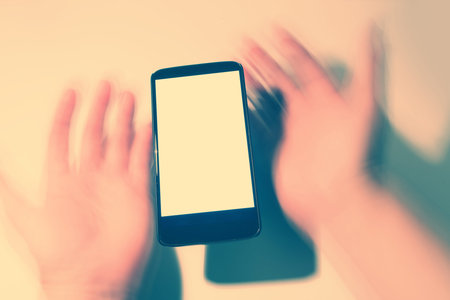 cellphone and blur hands with blank screen. communication concept.