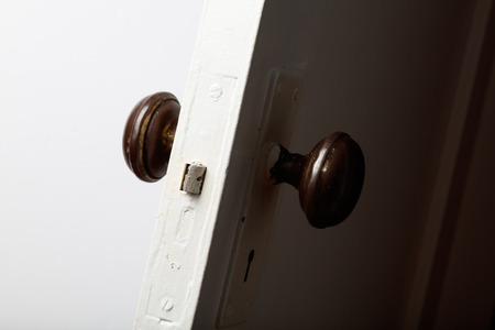 old wooden door with door knob, close up.の写真素材