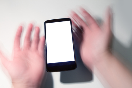 cellphone and blur hands with blank screen. communication concept.の写真素材