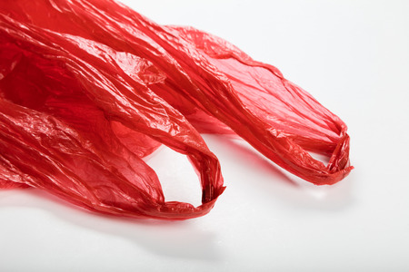 Red Plastic Bag close up with white backgroundの写真素材