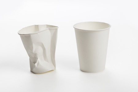 Crumbled White paper coffee cup on white background.の写真素材