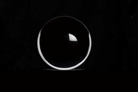 Transparent Crystal ball with black background , close up.