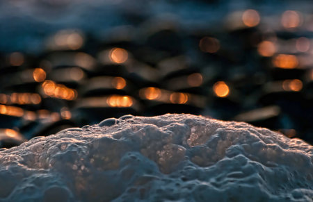 Close-up foam of sea in the sunsetの写真素材