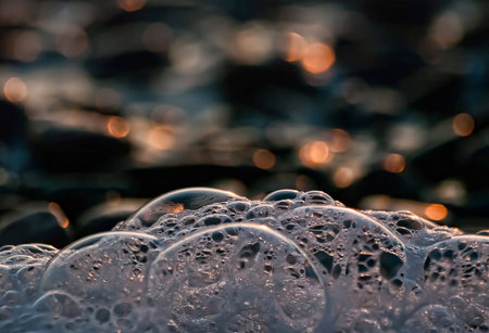 Close-up foam of sea in the sunsetの写真素材