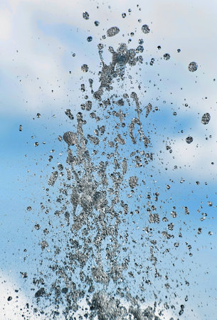 Fountain of water on a background of the skyの写真素材