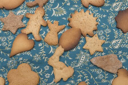 a lot of ginger cookies on bluish tablecloth
