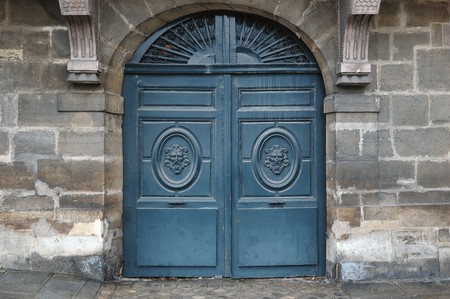 Old wooden door with metal and wooden ornamentsの写真素材