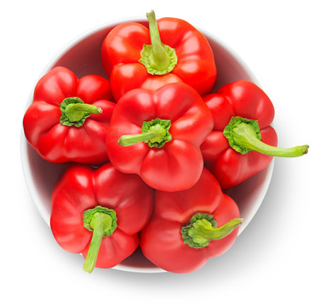 Bowl of red bell peppers isolated on white
