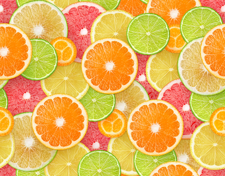 Citrus fruits background. Seamless pattern with pieces of orange, lemon, lime, grapefruit and kumquatの写真素材