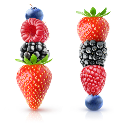 Isolated berries pyramids. Strawberry, blackberry, raspberry and blueberry on top of each other isolated on white backgroundの写真素材