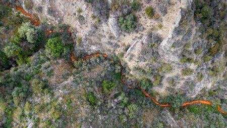 Aerial view of acid drainage from an abandoned copper mine in Kalavasos area, Cyprus. Odd red color of the stream derives from high levels of sulfuric acid and heavy metalsの写真素材