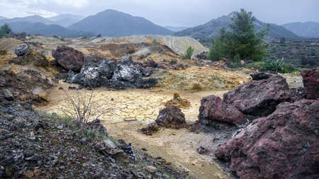 Piles of multicolored waste rocks and tailings near abandoned Memi mine in Xyliatos, Cyprus. Itâs the result of copper ore extraction in the areaの写真素材