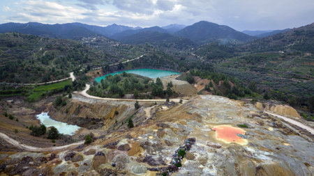 Multicolored waste rocks and tailings from mining near abandoned open pit Memi mine in Xyliatos,...