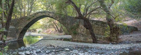 Panorama of Tzelefos single arch stone bridge in Paphos forest. The bridge was built during the Venetian period on Cyprus (1489-1571)の写真素材