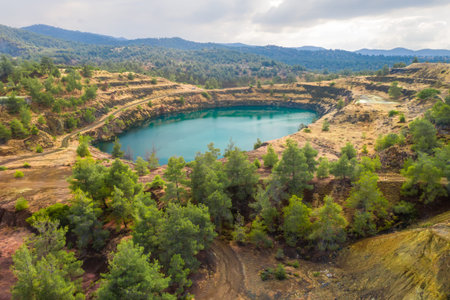 Restoration of former open pit copper mining area near Kapedes, Cyprus with forest restored over old...