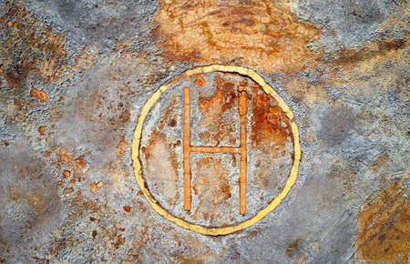 Rusty helipad at abandoned mine over rough stone surface, aerial view directly above. Dystopic post apocalyptic textureの写真素材