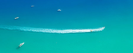 Speed boat with slider leave trail on water, sea panorama from above