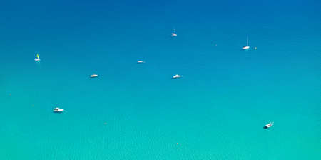 White boats at ancor on calm Mediterranean sea. Aerial minimal landscape panoramaの写真素材