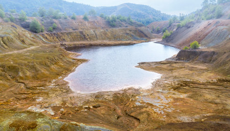 Contaminated surface of abandoned copper mine near Sia, Cyprus. Toxic lake and soil polluted by...