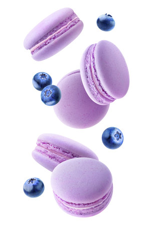Flying macaroon cookies with fruits in the air, vertical isolated on white backgroundの写真素材
