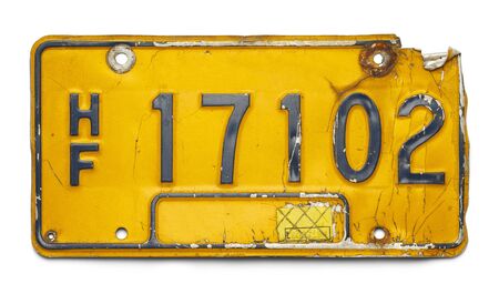 Old Yellow Bent Up License Plate Isolated on a White Background.の写真素材
