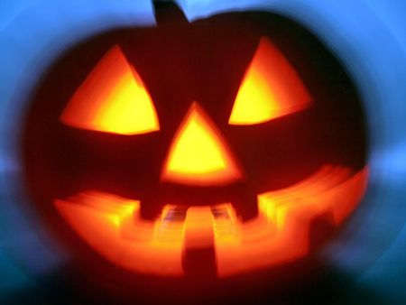 Halloween pumpkin head. Cold back light, scary smiling, warm light inside head.の写真素材