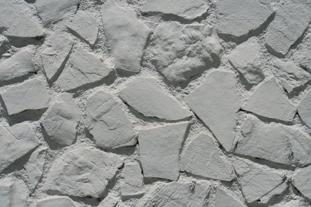White stone wall, big pieces of stone, all paint white.の写真素材