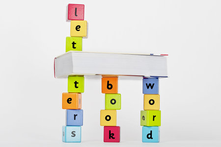 book and wooden blocks with letters stacket upの写真素材