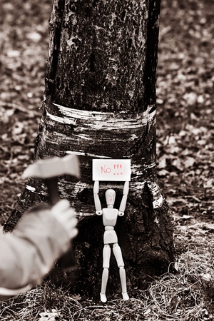 wooden model fighting against logging in sepia toneの写真素材