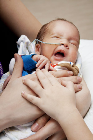 little premature boy with his family