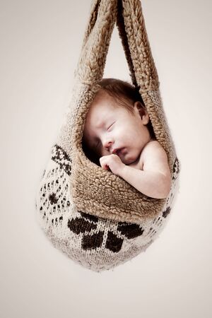 little baby hanging in the winter hat