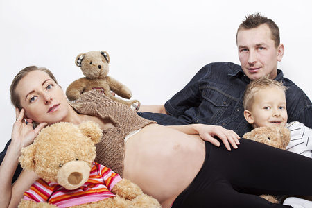 happy family posing with tree teddy bears