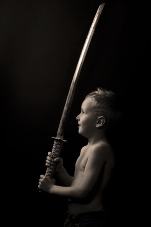 little boy posing with sharp samurai swordの写真素材