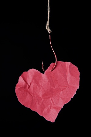 hanging paper heart ilustrating damaging effect of any addictionの写真素材