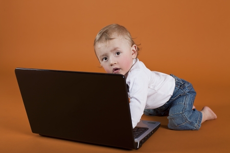 little boy sufring online for the shoesの写真素材