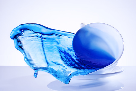 splash blue water in the flying cupの写真素材