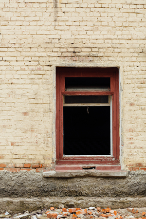 Window without glass in an abandoned brick building, devastationの写真素材