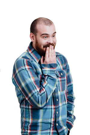 Portrait of a red-bearded, balding male brutal. White isolated background. A man in a blue plaid shirt. Shy giggles behind her hand. Looking away.の写真素材