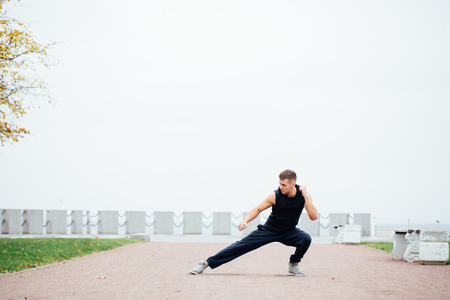 A young competitor does some warm up stretches before the big race. fighter, martial Artsの写真素材