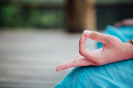 Woman meditating in the lotus position closeup. Hands close-up.の写真素材