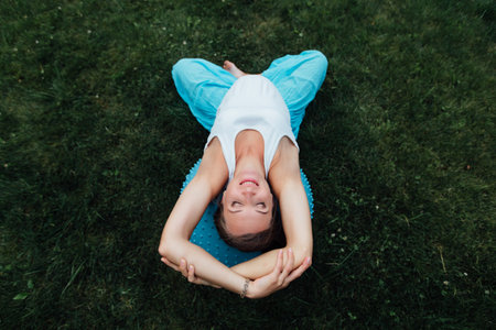 Happy pregnant yoga prenatal maternity doing different exercises with fitball. in park on the...