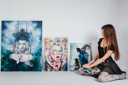 female artist at Picture canvas on white background. Girl painter with brushes and palette. Art creation concept.の写真素材