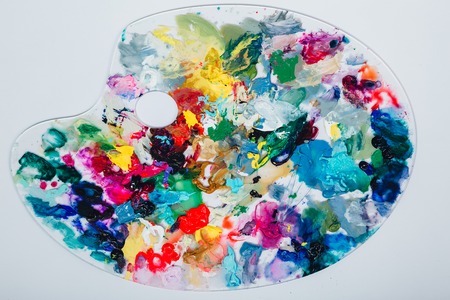 The artists palette stained with paint. On a white background, nobodyの写真素材