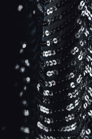 Fabric evening black dress girl with sequins, rhinestones. colorful sequined texture.の写真素材