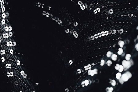 Fabric evening black dress girl with sequins, rhinestones. colorful sequined texture.の写真素材
