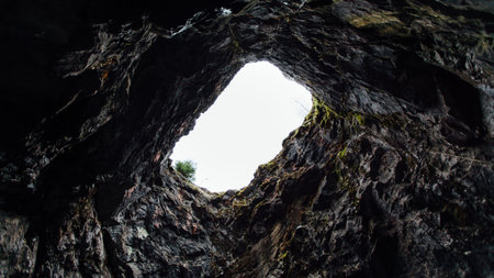 Look at the sky through the hole in the cave