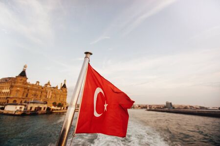 Flag of Turkey and lifebuoy on back of a boat in Bosphorus strait, Istanbul, Turkeyの写真素材