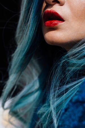 Fashion portrait of gorgeous girl with blue dyed hair long. The beautiful evening cocktail dress.の写真素材